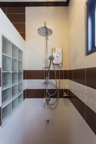 a shower in a bathroom with a shower head at The Best Ao Nang Villas in Ao Nang Beach