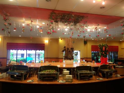 a dining room with a large table and chairs at Hotel Seri Malaysia Melaka in Melaka