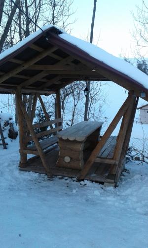 a wooden shelter with snow on top of it at Dacha PODOBOVETS 127 in Podobovets