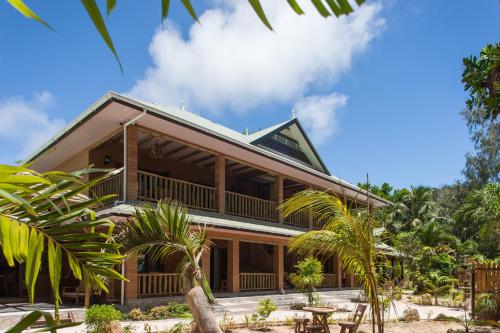 a house on the beach with palm trees at Anse Severe Beach Villas in La Digue