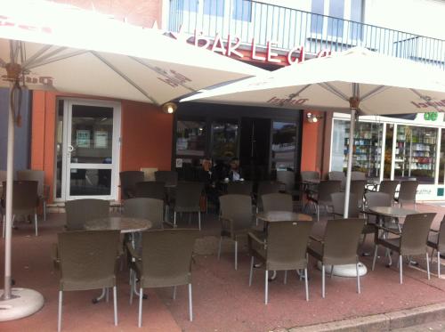a restaurant with tables and chairs and umbrellas at Hôtel Bar le Globe in Saint Die