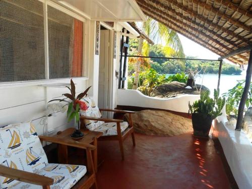 a living room with couches and a view of the ocean at Remo e Berenice in Nosy Komba