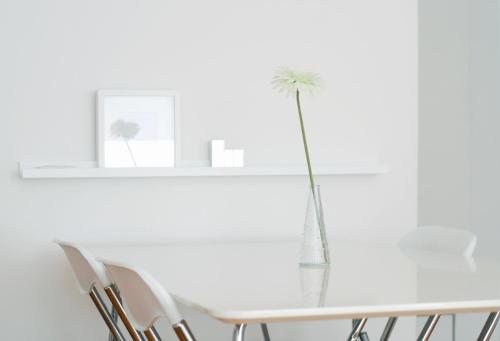 a white dining room with a white table and chairs at Miu Arena Apartment in Belgrade