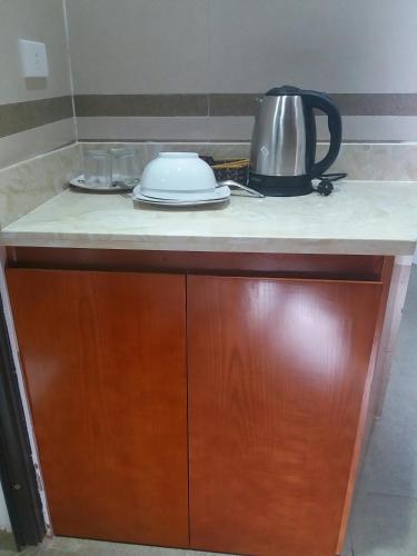 a kitchen counter with a tea kettle on top of it at Haengbok Hotel in Bắc Ninh