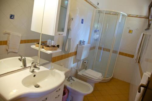 a bathroom with a sink and a shower and a toilet at Hotel Orsa Maggiore in Vulcano