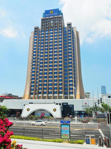 a large building with a car parked in front of it at Millennium Harbourview Hotel Xiamen-Near Metro Station & Zhongshan Road in Xiamen