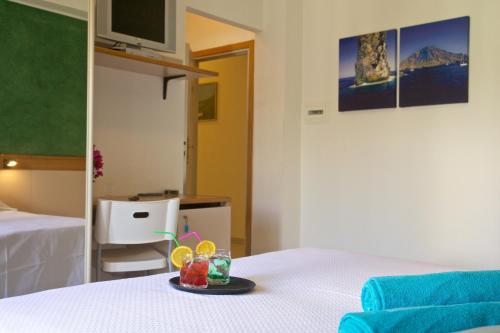 a room with a bed with a plate of food on it at Hotel Orsa Maggiore in Vulcano