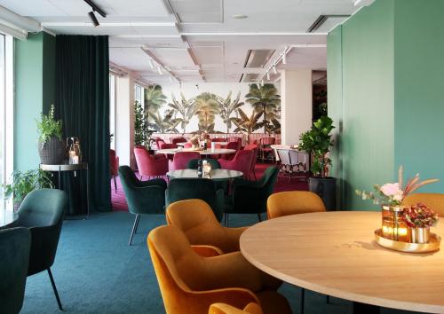 a dining room with tables and chairs and a room with tables and chairs at Gothia Towers & Upper House in Gothenburg