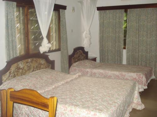 מיטה או מיטות בחדר ב-Kitolie Home and Lodge