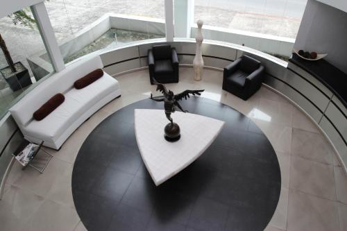 a living room with a table and chairs at Hotel Rio 1300 in Cuernavaca