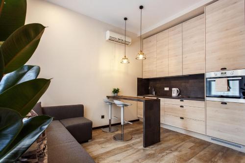 a kitchen with wooden cabinets and a counter top at Old Town Trio Apartments in Vilnius