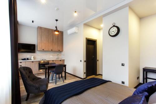 a bedroom with a bed and a table and a kitchen at Old Town Trio Apartments in Vilnius