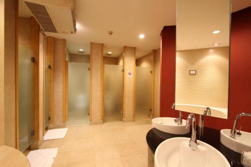 a bathroom with two sinks and a large mirror at Urbana Sathorn, Bangkok in Bangkok