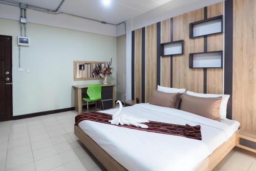 a bedroom with a bed with a white swan on it at Supreme Place SHA Plus in Khon Kaen