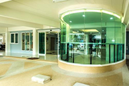 a lobby with a large glass wall at Supreme Place SHA Plus in Khon Kaen