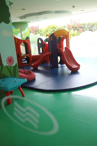 a childrens play area with chairs and a playground at Crowne Plaza Bandung by IHG in Bandung