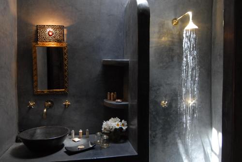 y baño con ducha, lavamanos y lavamanos. en Riad Ajmal, en Marrakech