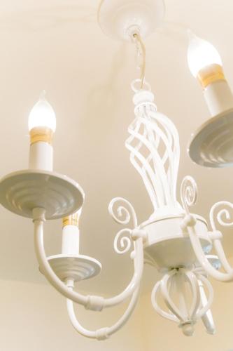 a white chandelier hanging from a ceiling at Lè mù in Taichung