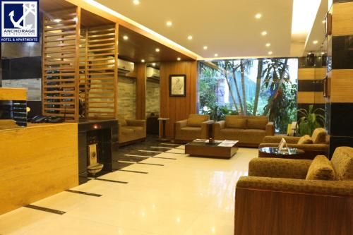 a lobby with couches and a fireplace in a building at Anchorage The Residence in Dhaka