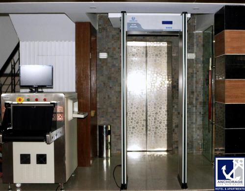 a glass door in a building with a tv on the wall at Anchorage The Residence in Dhaka
