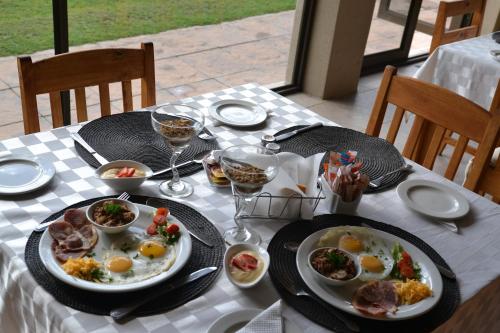 a table with plates of food and glasses of wine at Dilisca Guesthouse in Durbanville