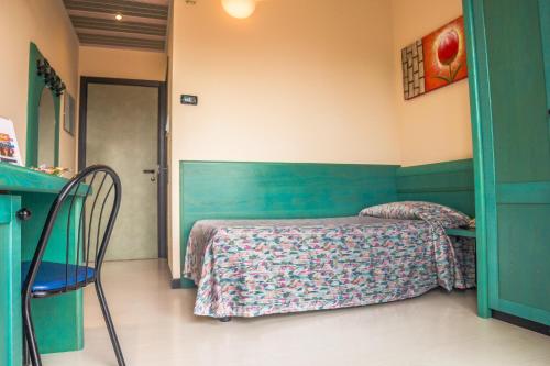 a bedroom with a bed and a table and chairs at Hotel Eden in Valeggio sul Mincio