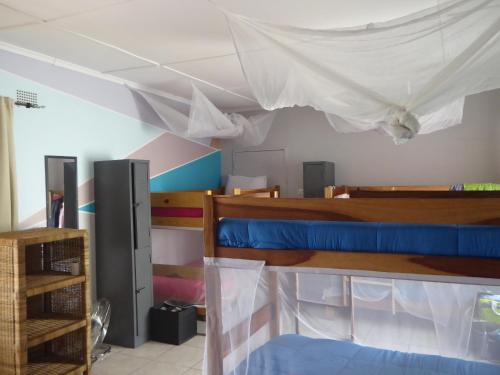 a room with two bunk beds and a ceiling at Natwange Backpackers in Lusaka