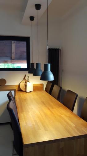 a dining room table with chairs and a television at Löwenherz in Göstling an der Ybbs