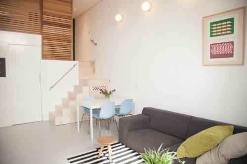 a living room with a couch and a table at hip & stylish apartment in center, near trainstation, 15 min walk in Amsterdam
