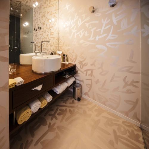 a bathroom with a sink and a mirror at Hotel Rathaus - Wein & Design in Vienna
