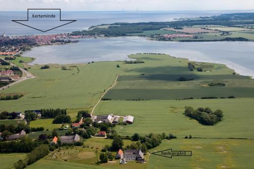 an aerial view of a village and a lake at Ferielejlighed på Rødkærgård in Kerteminde