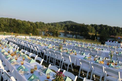 a long row of tables and chairs with food on them at Rough River Dam State Resort Park in Fentress McMahan