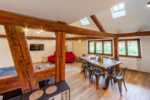a dining room with a table and chairs at Le gîte des Histoires in Kientzheim