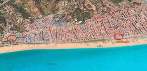 a map of a beach next to the water at The Hollidays Apartment in Calella