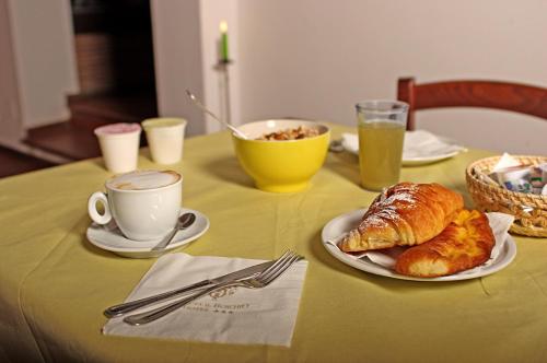 a table with a plate of croissants and a cup of coffee at Tenuta Il Burchio in Incisa in Valdarno