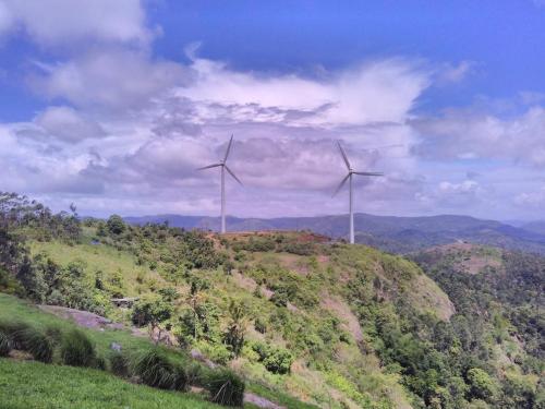two wind turbines on top of a hill at Skyrock Inn in Kattappana