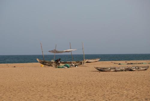 a couple of boats on a sandy beach at A&Y Wild Camp Ghana in Keta