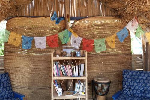 a room with a book shelf and a clothes line with towels at A&Y Wild Camp Ghana in Keta