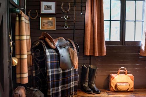 a bag and boots in a room with a window at The Stables in Kingston