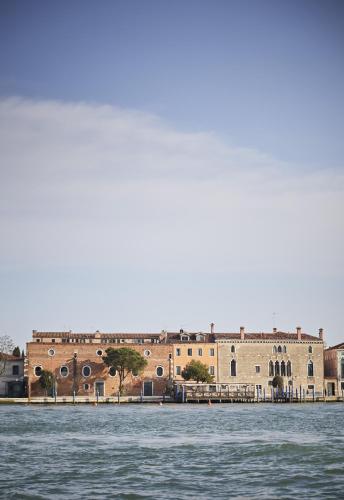 a large brick building next to a body of water at Hotel Cipriani, A Belmond Hotel, Venice in Venice