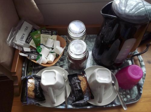 a glass table topped with a coffee maker and food at Maggie's in Inveraray