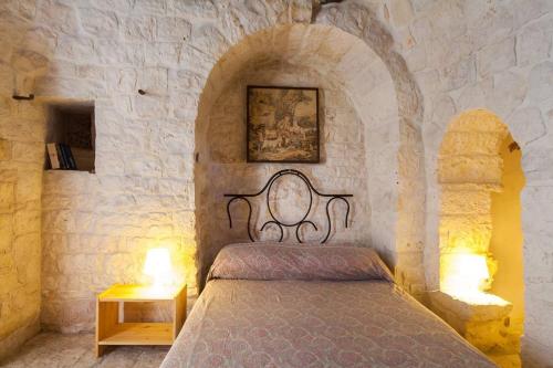 Giường trong phòng chung tại Trulli e Masseria Ianella