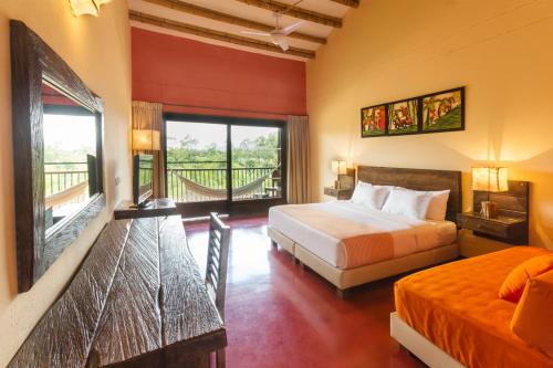 a hotel room with two beds and a balcony at Decameron Panaca - All Inclusive in Quimbaya