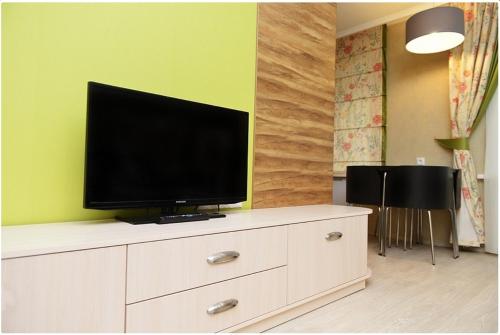 a television sitting on top of a dresser in a room at Apartment on Pichugina in Karagandy