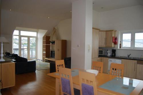 a kitchen and living room with a table and chairs at Harbour View Apartment Kinsale in Kinsale