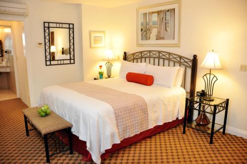 a bedroom with a large bed and two lamps at The Eagle Inn in Santa Barbara