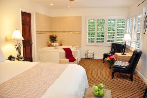a bedroom with a bed and a bath tub at The Eagle Inn in Santa Barbara