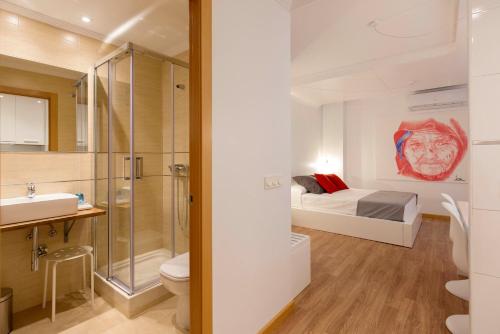 a bathroom with a toilet and a bed in a room at San Justo Plaza in Salamanca