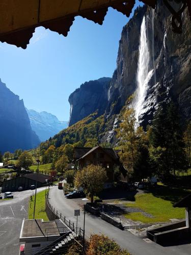 a waterfall on the side of a mountain at Angie's Apartments in Lauterbrunnen
