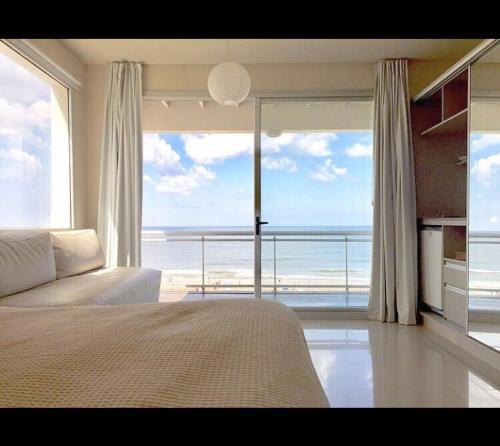 a bedroom with a bed and a view of the ocean at Mitre Al Mar in Ostende